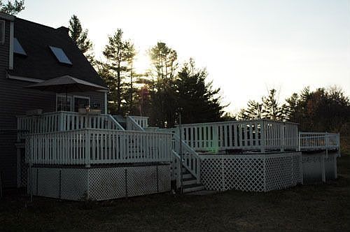 enourmous 3-level back deck with attached pool and hottub