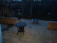 two-tiered patio backs to woods