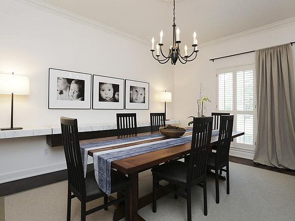 DINING ROOM (12'X16') High ceilings provide a feeling of spaciousness to the formal dining room. Crown molding, elegant chandelier, wood floor and plantation shutters complete the classic look. Dual paned windows installed in 2012.