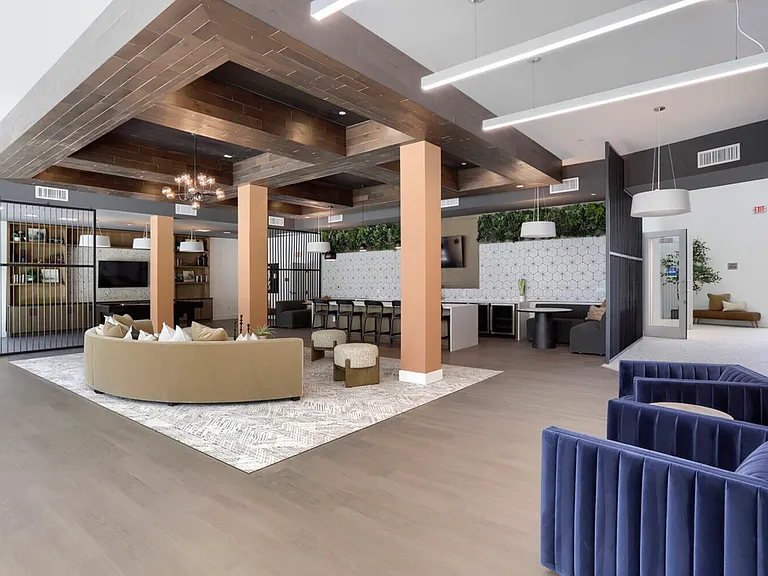 Everything in one place. The Garrett Uptown clubhouse great room brings together lounge seating, a full bar island, billiards, and a co-working space _ all under one stunning coffered ceiling.