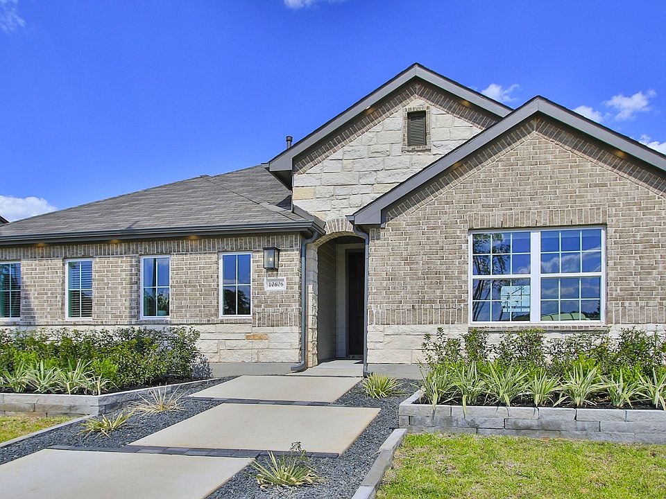 Distinguished single-story home with refined brickwork and gable roofing in the exclusive Cielo encl