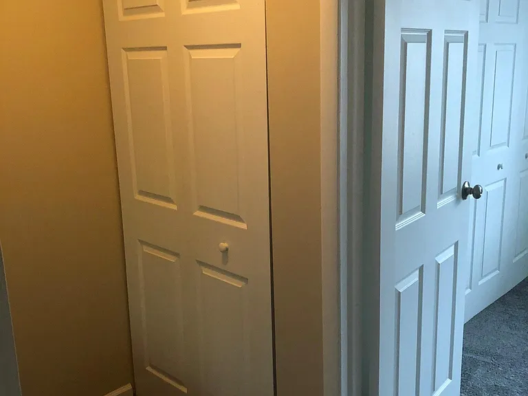 Linen closet in hallway across from bathroom