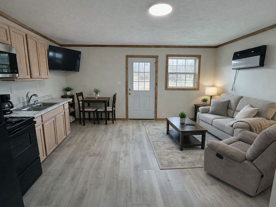 Open concept living and dining area.

Note: These are real photos of the cabin, we've just added AI staging in a few to help you picture how it could look furnished.