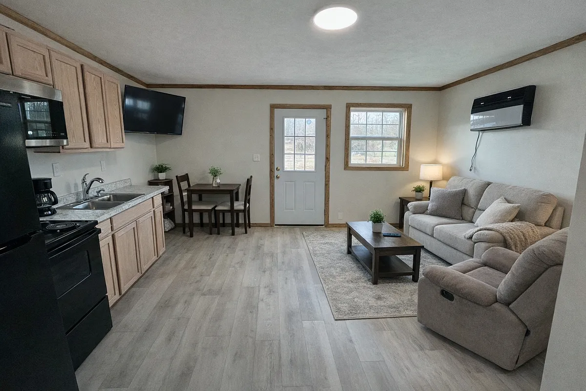 Open concept living and dining area.

Note: These are real photos of the cabin, we've just added AI staging in a few to help you picture how it could look furnished. - 6795 US Highway 50 E #23