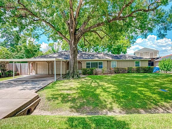 Quarter-acre lot, large double-wide driveway and attached carport.