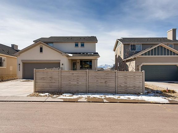 Exterior Garage Entry with Fully Fenced Yard
