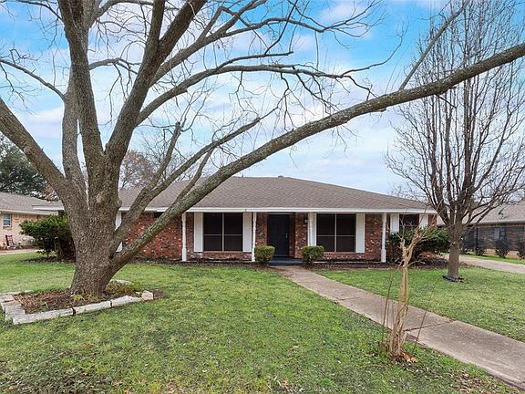 Single story home featuring a front lawn