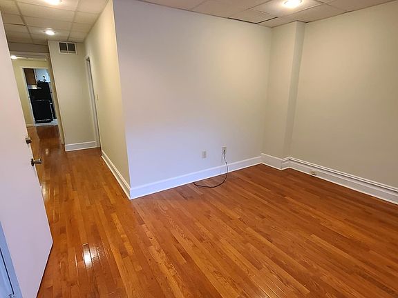 Large living room with hardwood flooring throughout and central A/C and efficient gas heat.