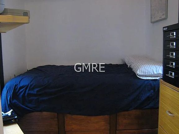 This is the bedroom that has two large windows, built in shelves and a built in captains bed with 9 drawers. In the back of the bed, there is also more storage. The mattress is not included.