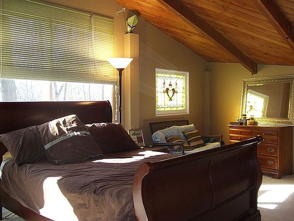 Master suite features tongue 'n groove ceiling & stained glass window