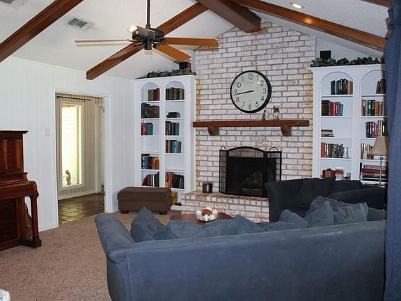 Den w/cathedral ceiling and cozy brick fireplace.