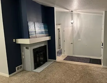 Living room with propane fireplace / entryway