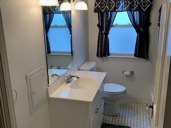 Bathroom on first floor with tile and new ceramic tub surround.
