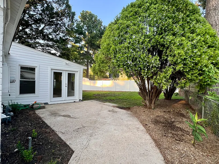 Side yard next to driveway.
Door leads to sunroom addition.