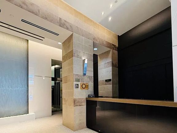 24 Hour Concierge Security & Service. Elegant Wall Fountain compliments entrance.