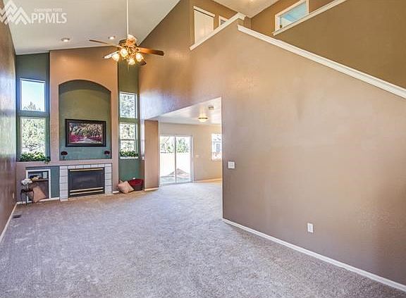 Walk into the massive living room with beautiful gas fireplace from the front entry way.