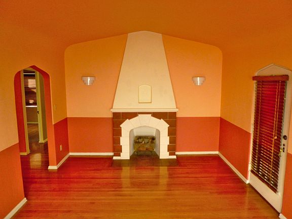 Living room with vintage gas fireplace, looking west.