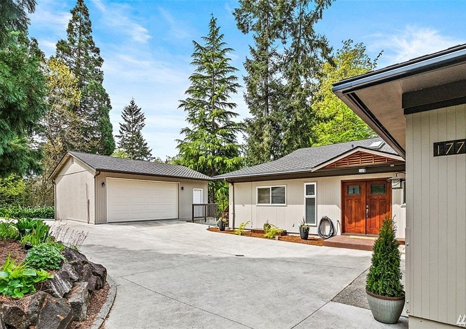 Circular Driveway & Double Door Entry into this Quality Daylight Basement Rambler Home with Detached 1,440 Shop
