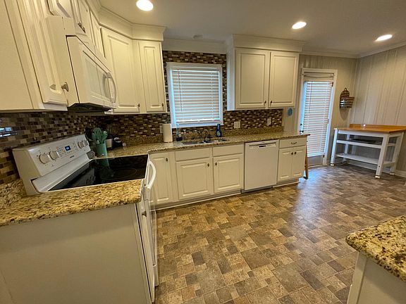 The full kitchen cannot be seen, but there is a plethora of cabinet and counter space for home cooked meals. The appliances included are: stove, microwave, dishwasher, refrigerator.