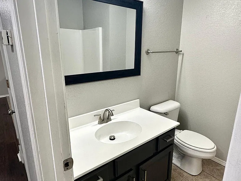 Updated guest bathroom with modern faucets.
