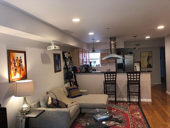 Living area into kitchen. Bar stools will remain if preferred by tenant.
