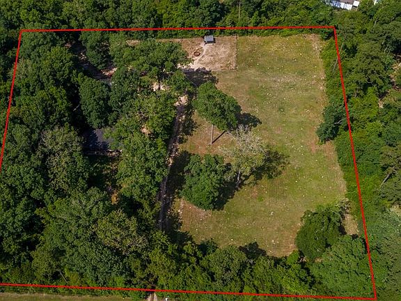 Home is situated on 3.8 lush and private acres.