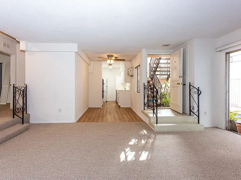 Dining room and kitchen with wood style flooring.