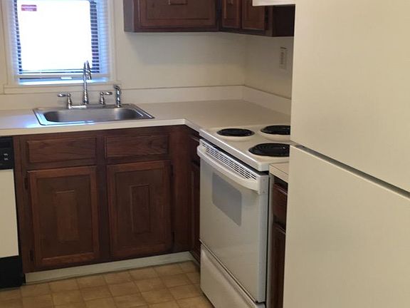 Kitchen, wall to wall cabinets, electric stove, dishwasher, and stainless sink