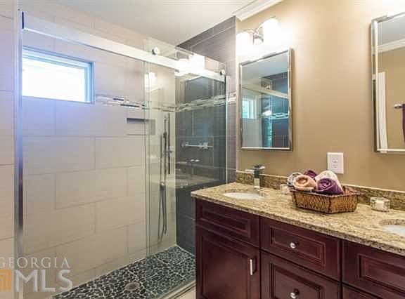 Great master renovation with glass shower w/bench, body-sprays, rain shower, and hand-held.  Double vanity w/ granite.