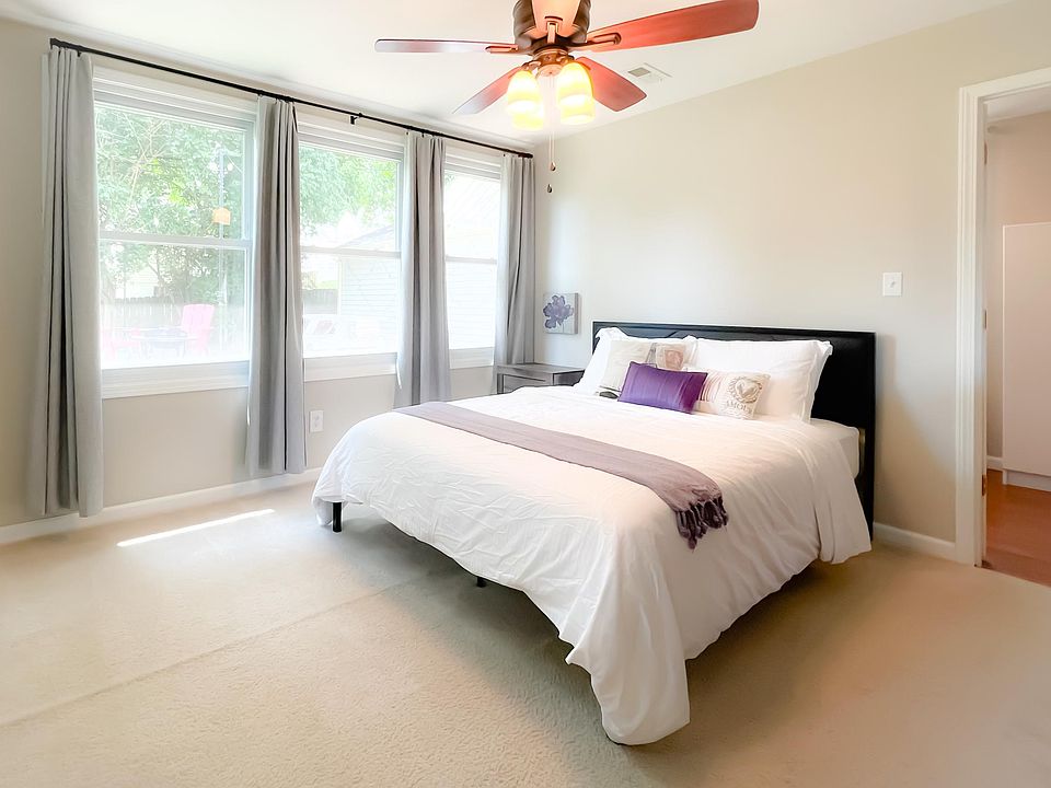 Primary bedroom has 2 closets, a private bathroom, large windows with blackout curtains, and a TV