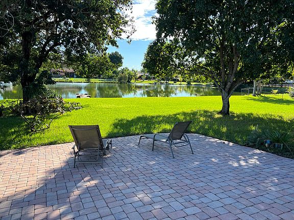 Huge mango tree and lovely view of the lake with a dock.