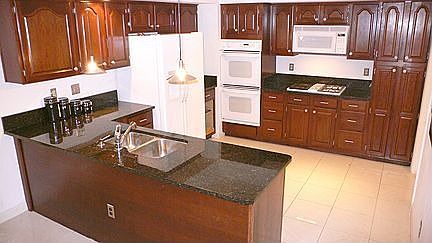 Brightly-lit Gourmet Kitchen with lots of upgrades: Granite, Appliances, Floor