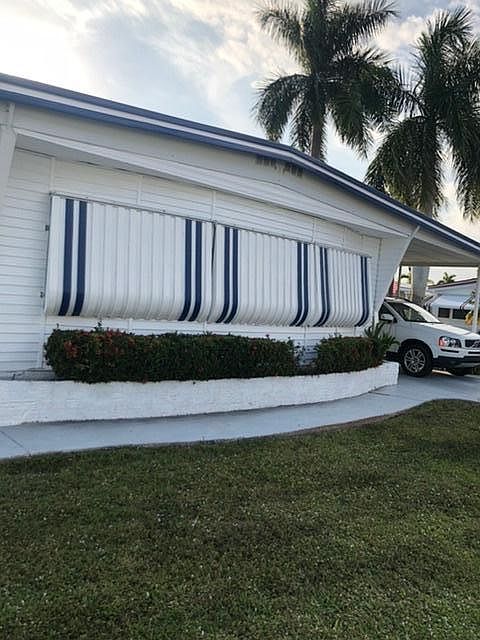 Front of home with awnings down.