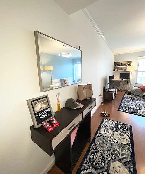 Entryway table with matching rug runner and full mirror.