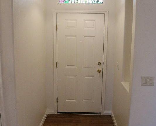 Entry has a beautiful stained-glass window and display area.