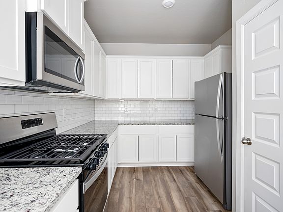 The kitchen has energy-efficient, stainless-steel appliances.
