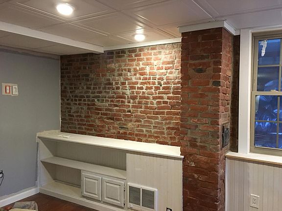 Built in book case, exposed brick living room