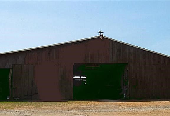 The main barn roof spans 75 feet that covers equipment storage, work shop, feed storage room, tack room and animal treatment area.