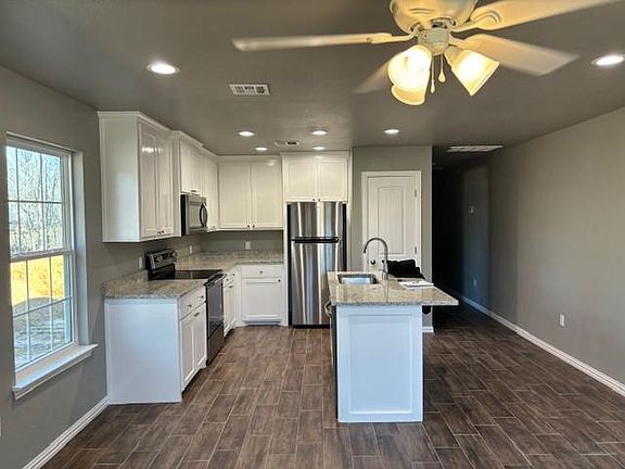 Kitchen with all new Whirlpool appliances, granite countertops.