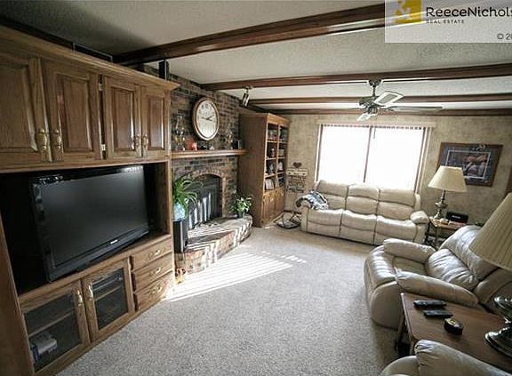 Living Room with Built-ins and Brick Fireplace.