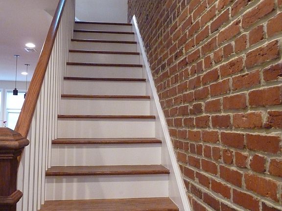 Staircase with exposed brick