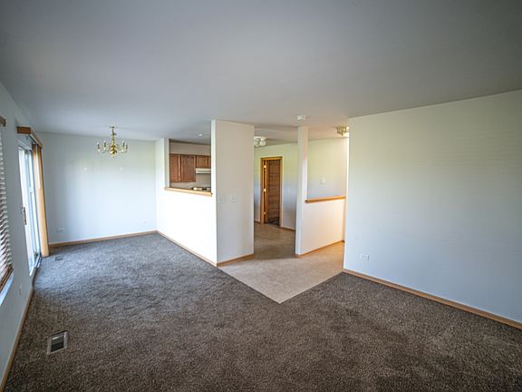 Dining area with slider leading to a stamped concrete patio