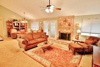 High ceiling, French doors and a wood or gas fireplace in Living Room