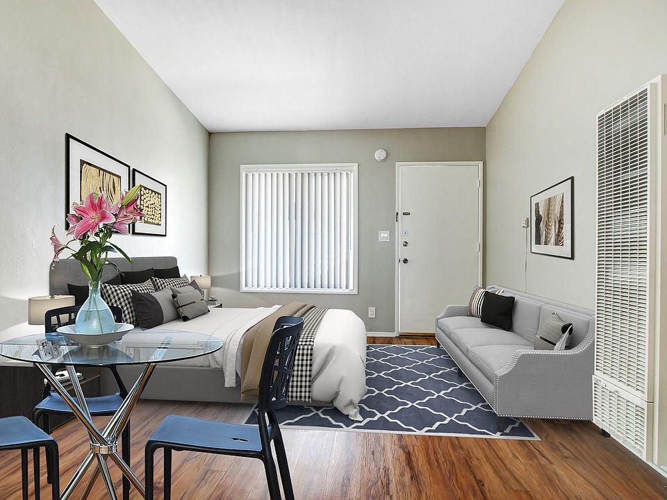 Wood-style flooring in sleeping and dining area, floor standing air conditioner