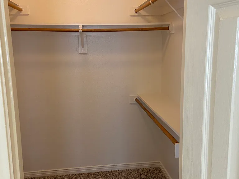 One of two primary walk in closets