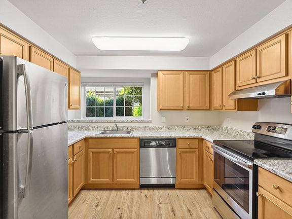 A bright kitchen with stainless steel finishes.