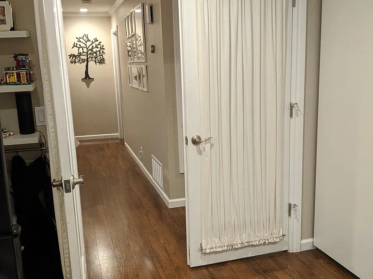 Photo from inside the third bedroom. Beautiful glass french doors with privacy curtains.