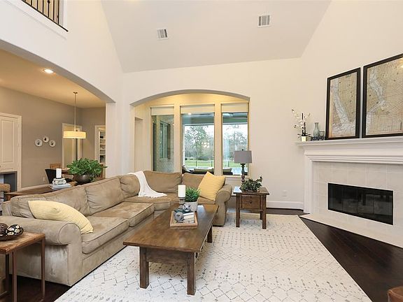 Wood floors throughout the downstairs! Vaulted living room ceiling plus wall of windows overlooking pool!