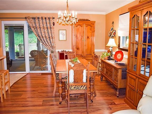 The living room flows into the spacious dining room and kitchen area, with of a view of the sunroom in the rear. Crown moulding 