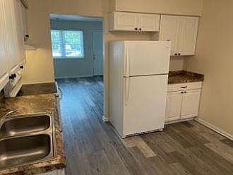 Kitchen view to living room and front door.